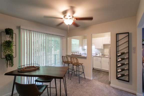 This is a photo of the kitchen from the dining room with pass through breakfast bar of the 550 square foot 1 bedroom, 1 bath, balcony floor plan model apartment at College Woods Apartments in thne NOrth College Hill neighborhood of Cincinnati, OH.