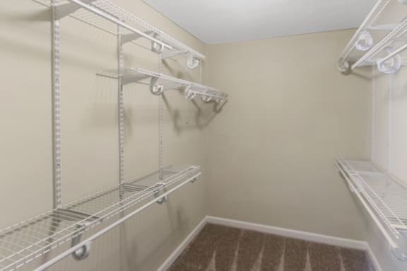 This is a photo of one of the two bedroom walk-in closets with custom closet shelving in an upgraded 650 square foot, 1 bedroom apartment at Deer Hill Apartments in Cincinnati, OH.