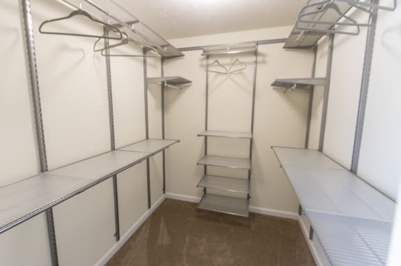 This is a photo of the bedroom walk-in closet with customizable closet system in the upgraded 650 square foot, 1 bedroom model apartment at Deer Hill Apartments in Cincinnati, Ohio.