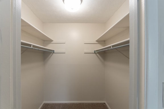 This is a photo of the primary bedroom walk-in closet in an upgraded 950 square foot, 2 bedroom apartment at Deer Hill Apartments in Cincinnati, OH.