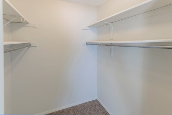 This is a photo of the master bedroom walk-in closet in a 950 square foot, standard 2 bedroom apartment at Deer Hill Apartments in Cincinnati, OH.
