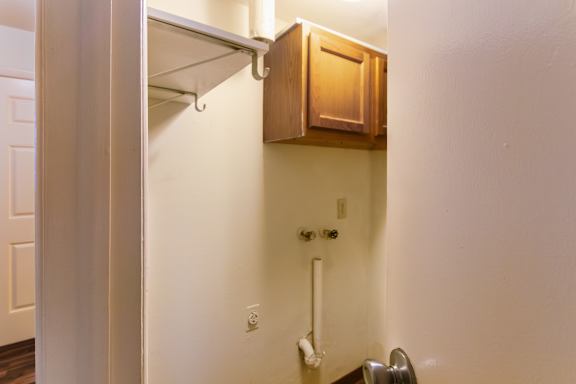 The utility closet with washer and dryer connections in the 1460 square foot, 3 bedroom, 2 and a half bath townhome at Fairfield Pointe Apartments in Fairfield, OH.