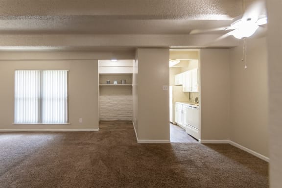 This is a photo of the living room and dining area in the 965 square foot 2 bedroom, 2 bath  apartment at Harvard Square Apartments, in Dallas, TX.