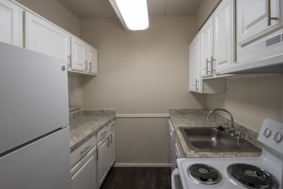 This is a photo of the kitchen of a 500 square foot 1 bedroom apartment at Harvard Square Apartments in Dallas, TX.