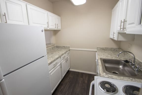 This is a photo of the kitchen of a 500 square foot 1 bedroom apartment at Harvard Square Apartments in Dallas, TX.