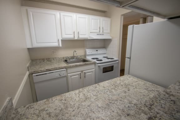 This is a photo of the kitchen of a 500 square foot 1 bedroom apartment at Harvard Square Apartments in Dallas, TX.