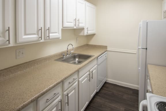 This is a photo of the kitchen in the 653 square foot 1 bedroom apartment at Harvard Square Apartments, in Dallas, TX.