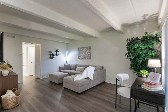 Open living room with neutral finishes and seating area in a 653-square-foot apartment home