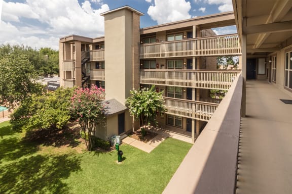 This is a photo of apartment entrances in the courtyard at Harvard Square Apartments, in the Vickery Meadow neighborhood of Dallas, TX.