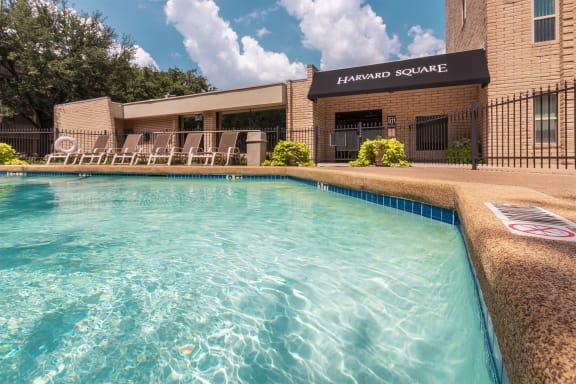 This is a photo of the pool area in the courtyard at Harvard Square Apartments, in the Vickery Meadow neighborhood of Dallas, TX.