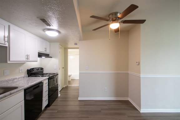 This is a photo of the kitchen and dining area with built-in bookshelf of the 560 square foot 1 bedroom, 1 bath Elm floor plan at Montana Valley Apartments in Cincinnati, OH.