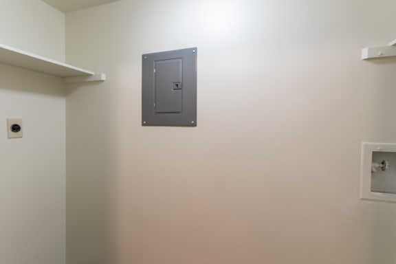 This is a photo the utility room with full-size washer/dryer connections of the 940 square foot, Sycamore 2 bedroom, 1 bath apartment at Montana Valley Apartments in the Westwood neighborhood of Cincinnati, OH.