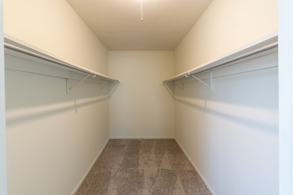 This is a photo the huge primary bedroom walk-in closet of the 940 square foot, Sycamore 2 bedroom, 1 bath apartment at Montana Valley Apartments in the Westwood neighborhood of Cincinnati, OH.