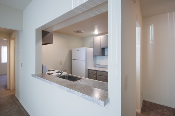This is a photo the kitchen through the pass-through window in the 833 square foot, Chestnut, 2 bedroom apartment at Montana Valley Apartments in Cincinnati, OH.