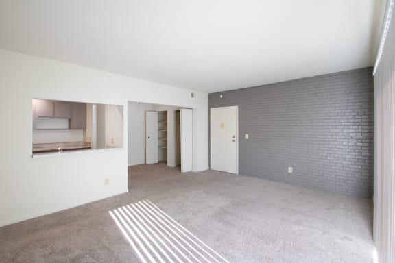 This is a photo the living room with painted brick accent wall of the 833 square foot Chestnut, 2 bedroom apartment at Montana Valley Apartments in Cincinnati, OH.
