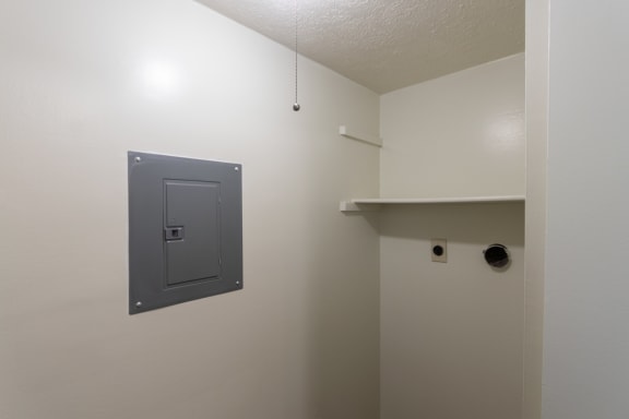 This is a photo of the utility room with full-sized washer dryer connections of the 716 square foot 1 bedroom, 1 bath Cypress floor plan at Montana Valley Apartments in Cincinnati, OH.