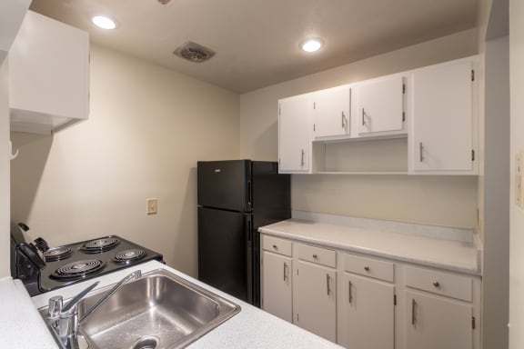 This is a photo the kitchen with white cabinets in the 925 square foot, Hazelnut 2 bedroom, 1 bath apartment at Montana Valley Apartments in the Westwood neighborhood of Cincinnati, OH.