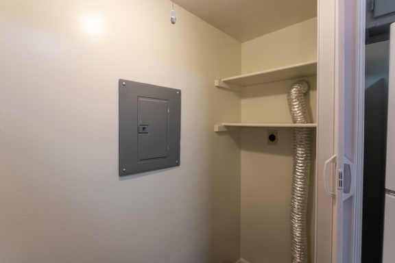 This is a photo of the utility closet with full-size washer and dryer connections of the 836 square foot 2 bedroom, 1 bath Hickory floor plan at Montana Valley Apartments in Cincinnati, OH.