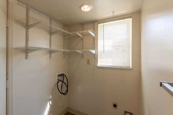 This is a photo of the half bath containing full-size wah=sher and dryer connections in the 1310 square foot 3 bedroom, 1.5 bath Pine floor plan at Montana Valley Apartments in Cincinnati, OH.