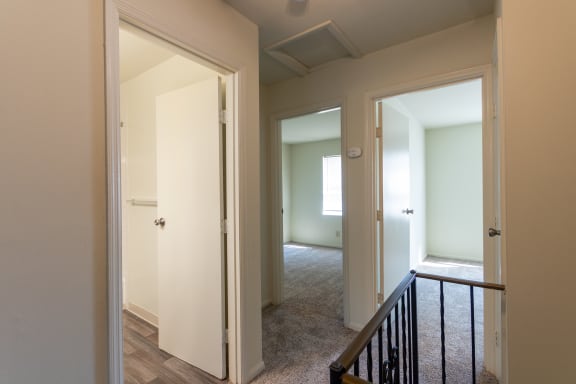 This is a photo of the upstairs hallway facing the bathroom and 2 bedrooms of the 1310 square foot 3 bedroom, 1.5 bath Pine floor plan at Montana Valley Apartments in Cincinnati, OH.