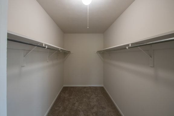 This is a photo the huge primary bedroom walk-in closet of an upgraded 1030 square foot, Oak 2 bedroom, 1 bath apartment at Montana Valley Apartments in the Westwood neighborhood of Cincinnati, OH.