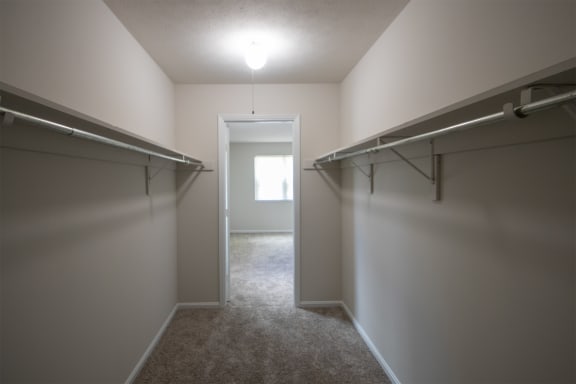 This is a photo the huge primary bedroom walk-in closet of an upgraded 1030 square foot, Oak 2 bedroom, 1 bath apartment at Montana Valley Apartments in the Westwood neighborhood of Cincinnati, OH.