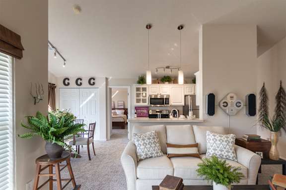 This is a photo of the kitchen and dining area from the living room in the 1016 square foot, 2 bedroom, 2 bath Nautica floor plan at Nantucket Apartments in Loveland, OH.