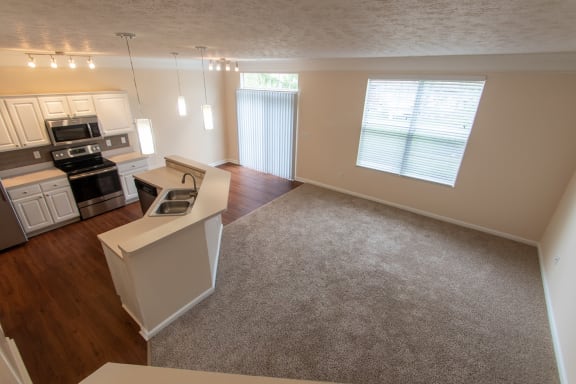 This is a photo of the living room from the stairwell in the 1578 square foot, 3 bedroom, 2 and 1/2 bath Flagship floor plan at Nantucket Apartments in Loveland, OH.
