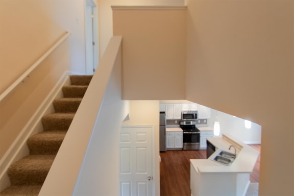 This is a photo of the kitchen from the stairwell in the 1578 square foot, 3 bedroom, 2 and 1/2 bath Flagship floor plan at Nantucket Apartments in Loveland, OH.
