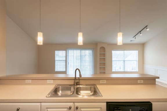This is a photo of the living room from the kitchen in the 2 bedroom, 2 bath Islander floor plan at Nantucket Apartments in Loveland, OH.