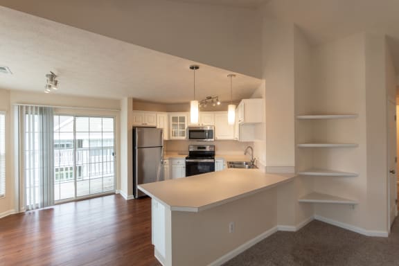 This is a photo of the dining area and kitchen in the 1255 square foot, 2 bedroom, 2 bath Lighthouse floor plan with vaulted ceilings at Nantucket Apartments in Loveland, OH.