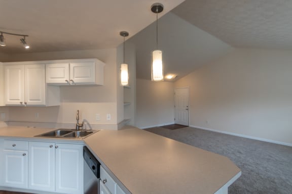 This is a photo of the living room from the kitchen in the 1255 square foot, 2 bedroom, 2 bath Lighthouse floor plan with vaulted ceilings at Nantucket Apartments in Loveland, OH.