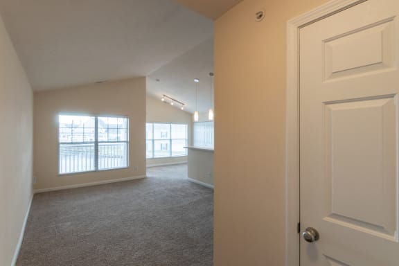 This is a photo of the living room from the entryway in the 1016 square foot, 2 bedroom, 2 bath Nautica floor plan with vaulted ceilings at Nantucket Apartments in Loveland, OH.