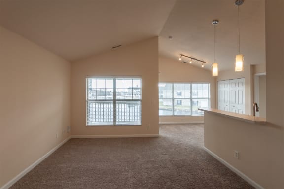 This is a photo of the living room in the 1016 square foot, 2 bedroom, 2 bath Nautica floor plan with vaulted ceilings at Nantucket Apartments in Loveland, OH.