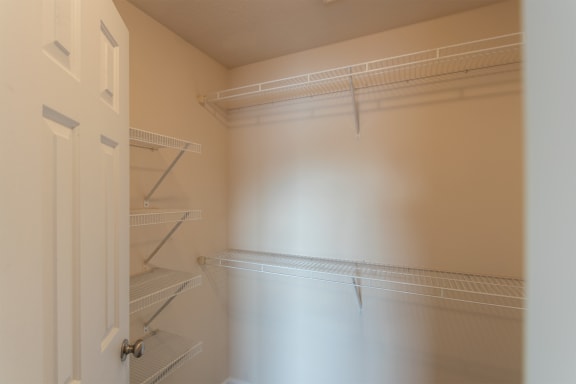 This is a photo of the primary bedroom walk-in closet in the 1016 square foot, 2 bedroom, 2 bath Nautica floor plan with vaulted ceilings at Nantucket Apartments in Loveland, OH.