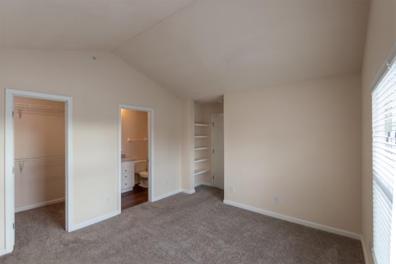 This is a photo of the primary bedroom in the 1016 square foot, 2 bedroom, 2 bath Nautica floor plan with vaulted ceilings at Nantucket Apartments in Loveland, OH.
