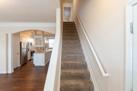 This is a photo of the stairs to the second floor in the 1498 square foot, 2 bedroom, 2 and 1/2 bath Schooner floor plan at Nantucket Apartments in Loveland, OH.