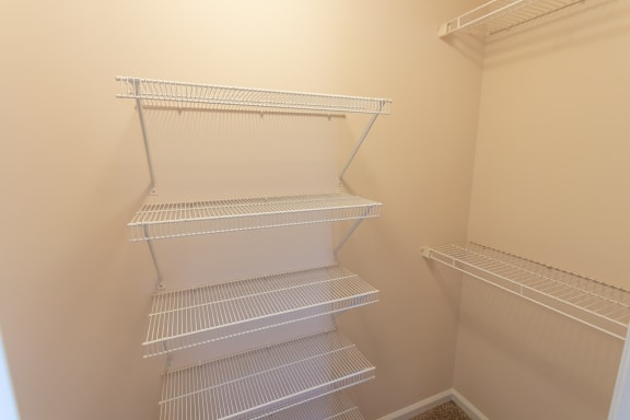 This is a photo of the one of the walk-in closets in the primary bedroom in the 1498 square foot, 2 bedroom, 2 and 1/2 bath Schooner floor plan at Nantucket Apartments in Loveland, OH.