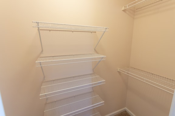 This is a photo of the one of the walk-in closets in the master bedroom of the 1498 square foot, 2 bedroom, 2 and a half bath Schooner floor plan at Nantucket Apartments in Loveland, OH.