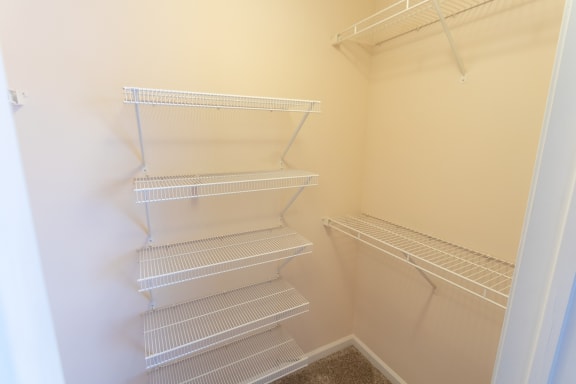 This is a photo one of the primary bedroom walk-in closets in the 1389 square foot, 2 bedroom, 2 and a 1/2 bath Yachtsman floor plan at Nantucket Apartments in Loveland, OH.