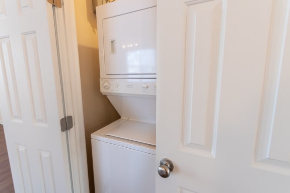 This is a photo of the stackable washer and dryer in the utility closet in the 1389 square foot, 2 bedroom, 2 and a 1/2 bath Yachtsman floor plan at Nantucket Apartments in Loveland, OH.