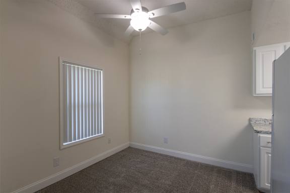 A dining Room with a white ceiling fan in a 1 bedroom, 1 bath apartment home at Princeton Court Apartments in the Vickery Midtown neighborhood of Dallas, TX.