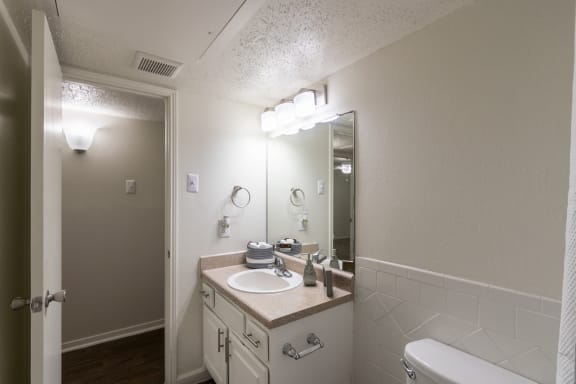 Walk-In Showers With Built-In Bench And Glass Enclosure at Princeton Court, Texas, 75231
