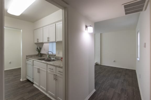 This is a photo of the kitchen from the entryway of the 970 square foot 2 bedroom, 2 bath apartment at Preston Park Apartments in Dallas, TX