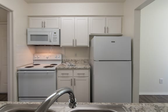 This is a photo of the kitchen in the 970 square foot 2 bedroom, 2 bath apartment at Preston Park Apartments in Dallas, TX