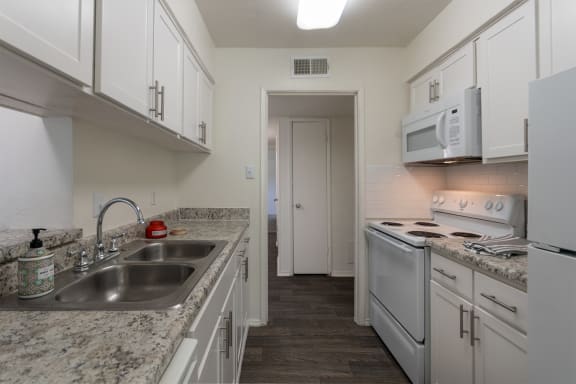 This is a photo of the kitchen room in the 970 square foot 2 bedroom, 2 bath apartment at Preston Park Apartments in Dallas, TX