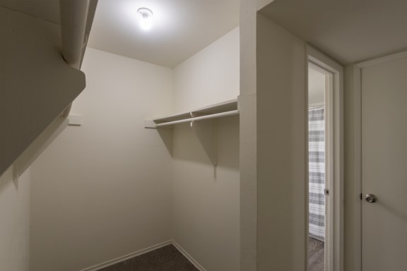 This is a photo of the primary bedroom walk-in closet in the 970 square foot 2 bedroom, 2 bath apartment at Preston Park Apartments in Dallas, TX