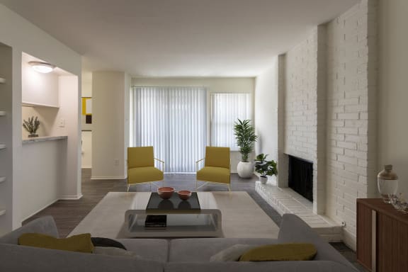 This is a photo of a virtually staged living room room in the 970 square foot 2 bedroom, 2 bath apartment at Preston Park Apartments in Dallas, TX