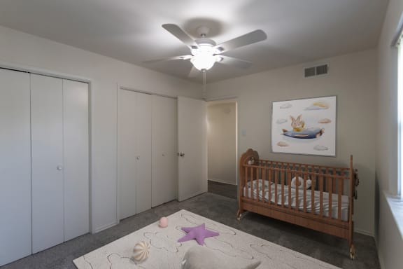 This is a photo of a virtually staged second bedroom room in the 970 square foot 2 bedroom, 2 bath apartment at Preston Park Apartments in Dallas, TX