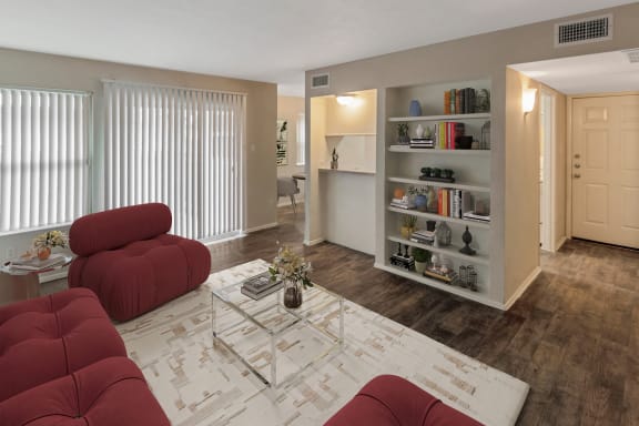 This is a photo of a virtually staged living room in the 650 square foot 1 bedroom, 1 bath apartment at Preston Park Apartments in Dallas, TX.